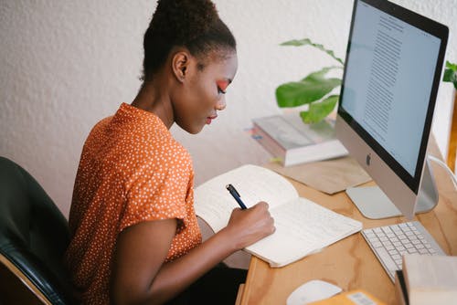 Woman at desk taking notes